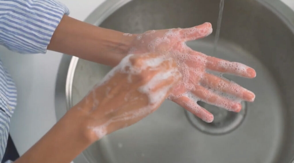 Washing hands with foaming lotion soap