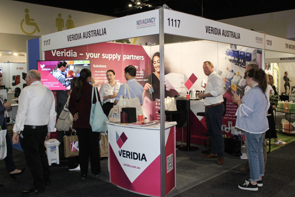 Veridia Australia stand at NoVacancy 2024, with team members (in white shirts) talking to expo visitors