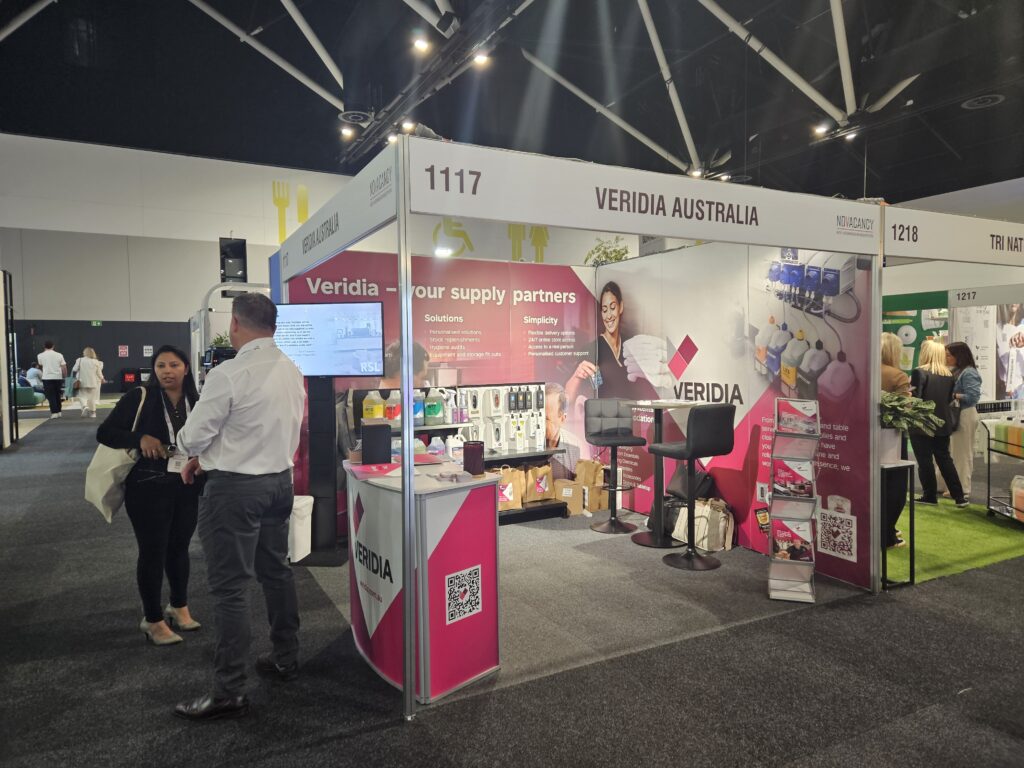 Veridia Australia stand at NoVacancy 2024, with team member Chris talking to an expo visitor